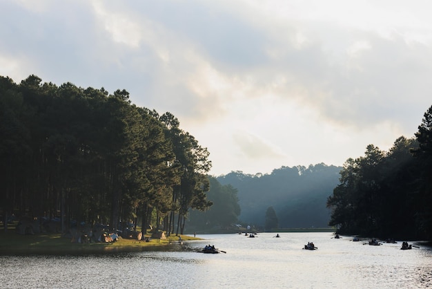 Silhouette group of tourists are rafting in morning sunlight at reservoir Pang Ung landmark mea hong son province Thailand