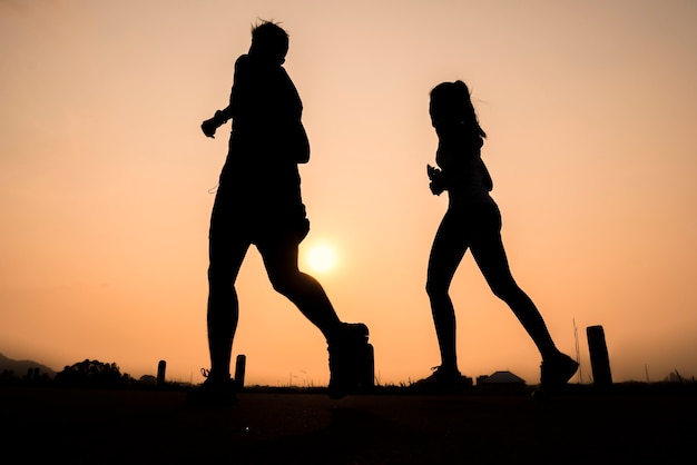 Silhouette group of young healthy lifestyle running at sunrise