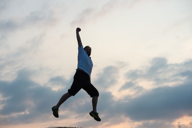 silhouette of happy guy enjoying himself