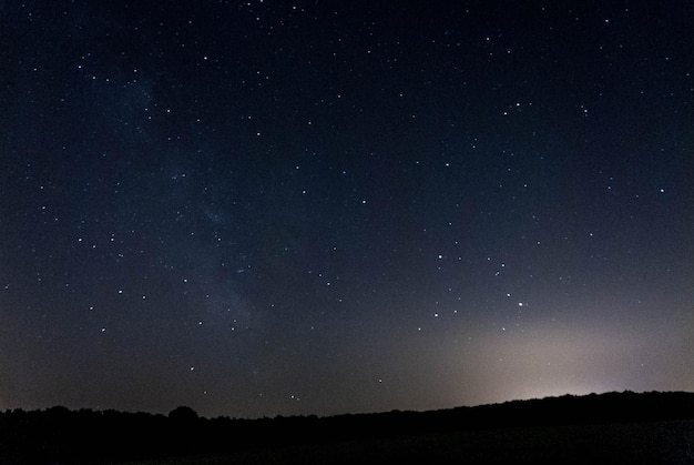 Silhouette hill against star field