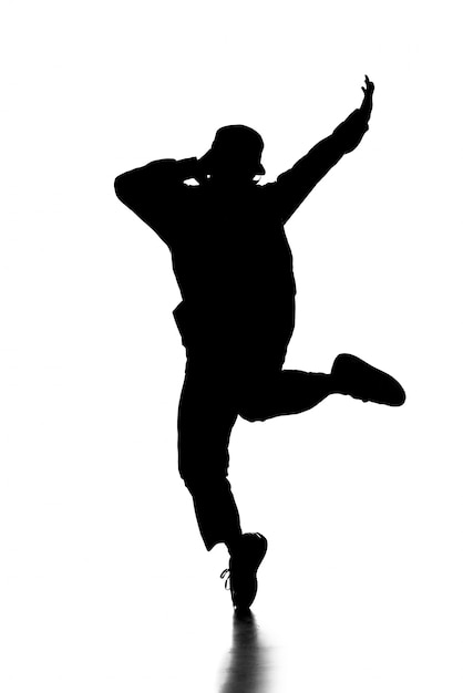 Photo silhouette of hip hop dancer is showing some movements.