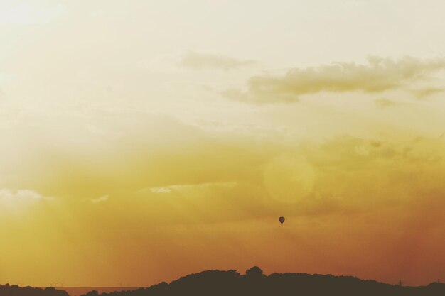 Silhouette of hot air balloon against sky during sunset