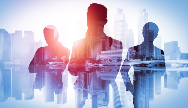 Silhouette image of business people group on city background