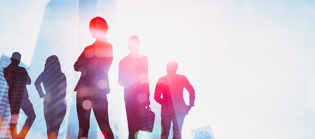 Silhouette image of business people group on city background