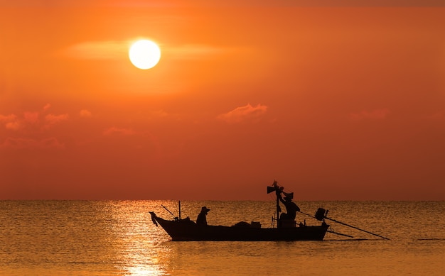 Silhouette image of Fishermen in fishing boat 