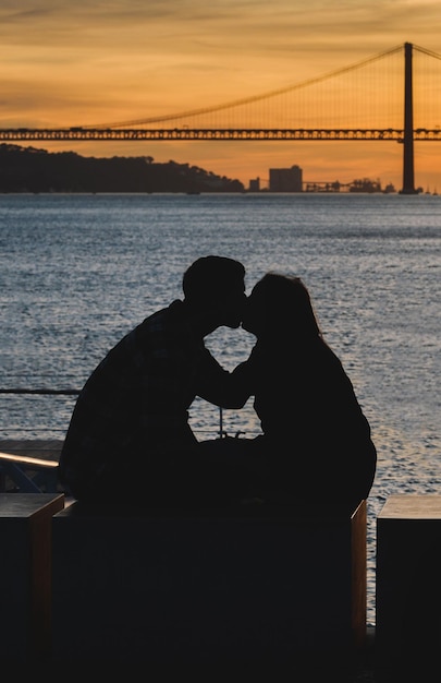 Silhouette of a kissing couple with seascape on the background