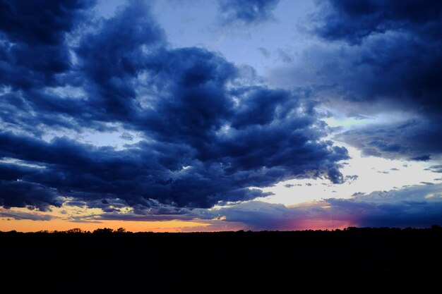 Silhouette of landscape against cloudy sky