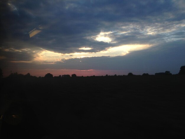 Silhouette of landscape against cloudy sky