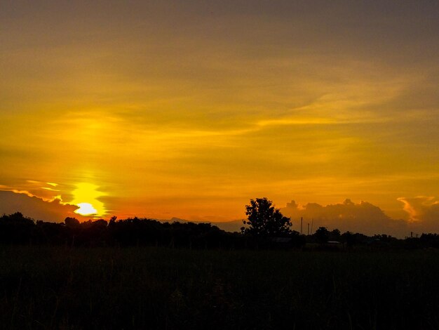 Silhouette landscape against dramatic sky during sunset