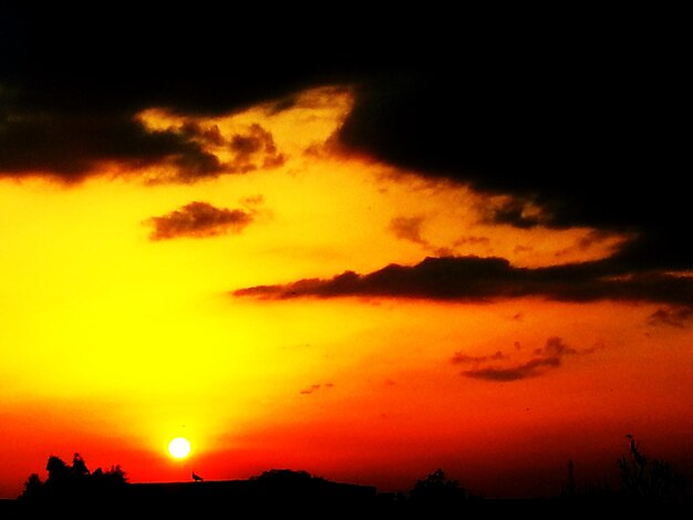 Silhouette of landscape against dramatic sky