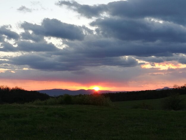 Silhouette landscape against sky during sunset