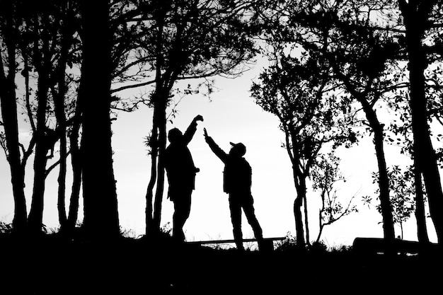 silhouette of love couple in trees border, back and white tone