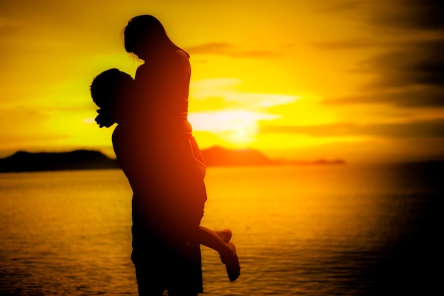 Silhouette lovers at the beach with sunsetCouple in love having romantic tender moments at sunsetlove and valentines concept