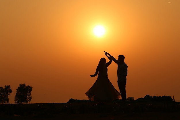 Silhouette loving couple on the beach at sunset