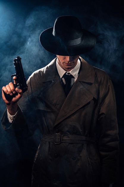 Silhouette of a male detective in a coat and hat with a gun in his hands A dramatic noir portrait in the style of books and detective films of the 1950s