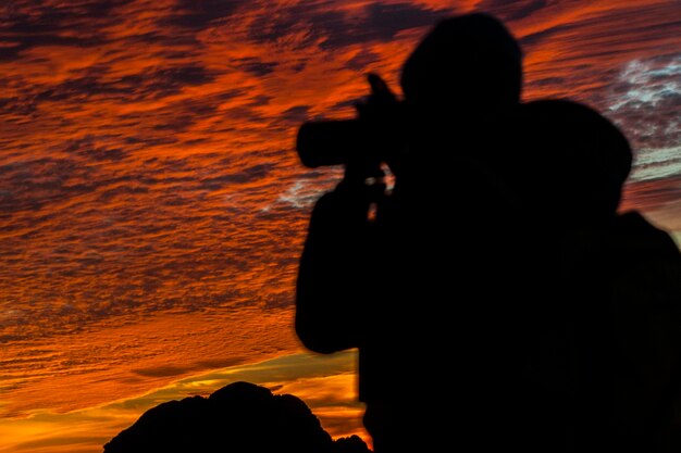 Silhouette man on beach during sunset