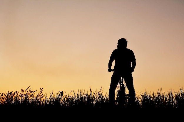 silhouette of man on bike
