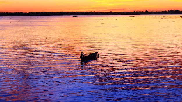 Silhouette man in the boat