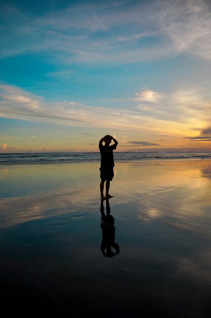 Photo silhouette of a man enjoying the clear afternoon sky