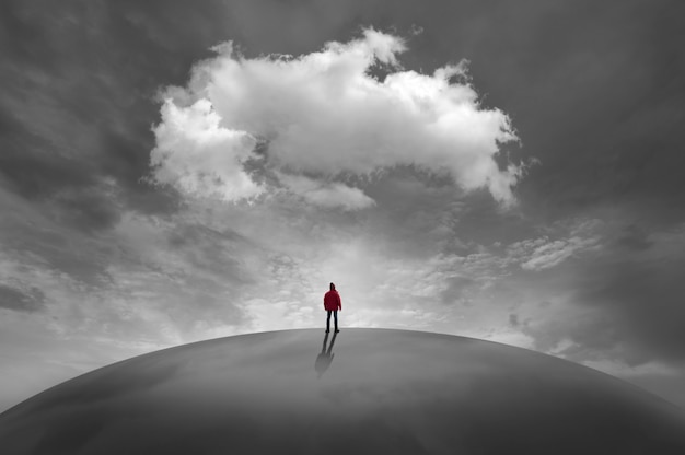 Silhouette of man in front of clouds