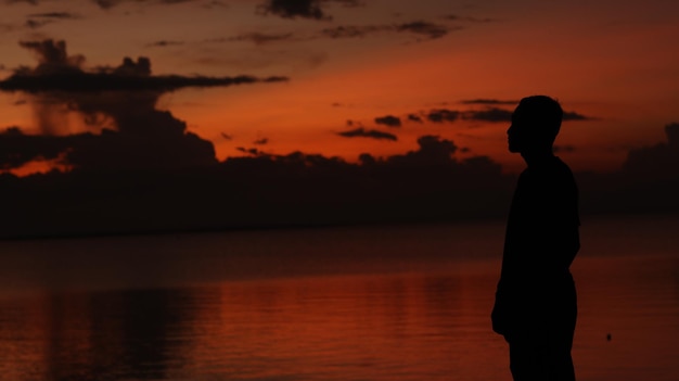 silhouette of man on the lake