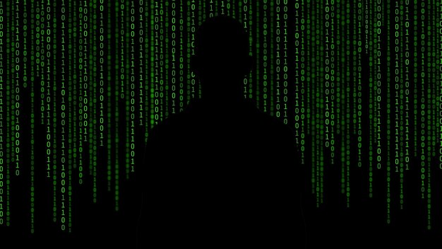 Silhouette man standing by binary codes against black background