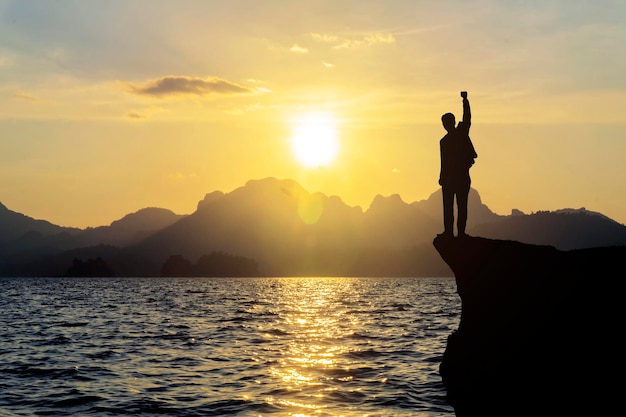 Silhouette of man standing on the mountainsuccess concept scene Conceptual design And especially with the beauty of limestone mountains