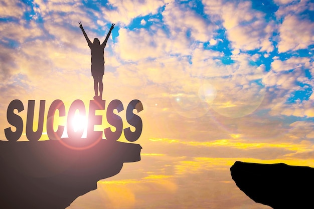 Photo silhouette man standing on success at cliff against cloudy sky during sunset