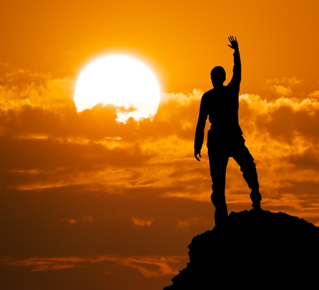 Silhouette of man on top of montain