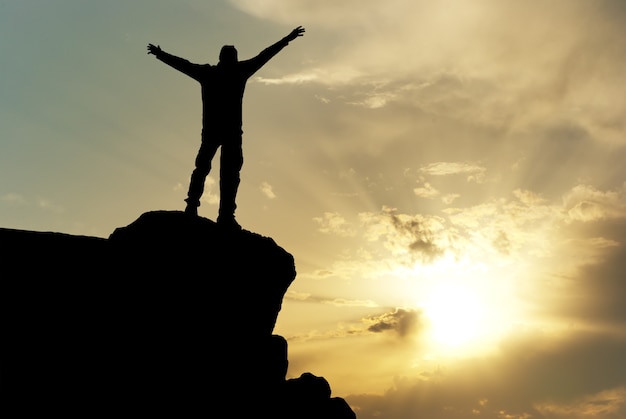 Silhouette of man on top of montain