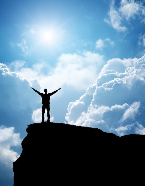 Silhouette of man on top of mountain