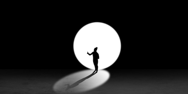 Silhouette of man walking in the night toward the light, view from above