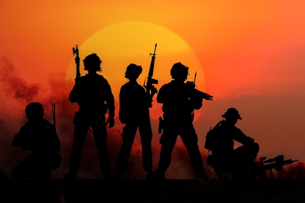 The silhouette of a military soldier with the sun as a marine\
corps for military operations