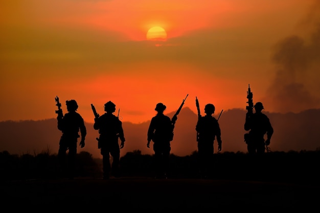 The silhouette of a military soldier with the sun as a Marine Corps for military operations