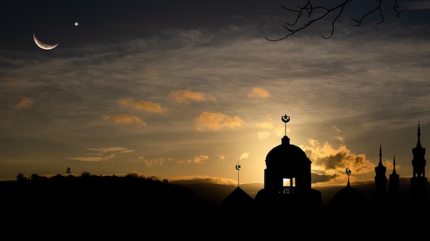 A silhouette of a mosque with a dome at the top of it.