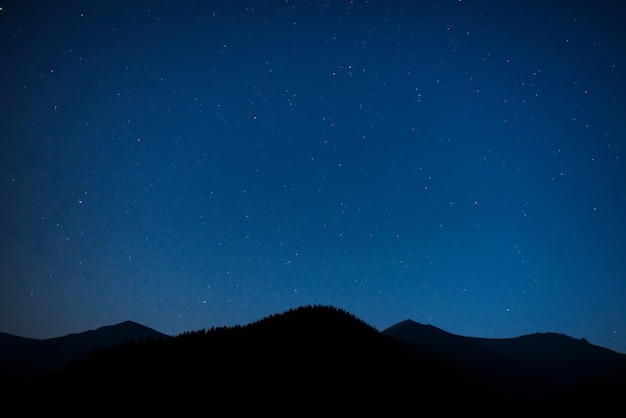 Silhouette of mountain range at night