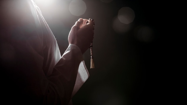 Silhouette of muslim woman praying