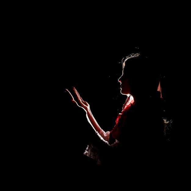 Silhouette of muslim woman praying