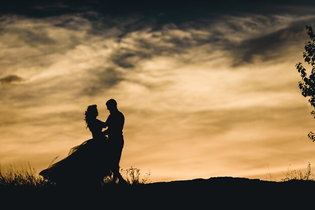 Silhouette of newlyweds dancing