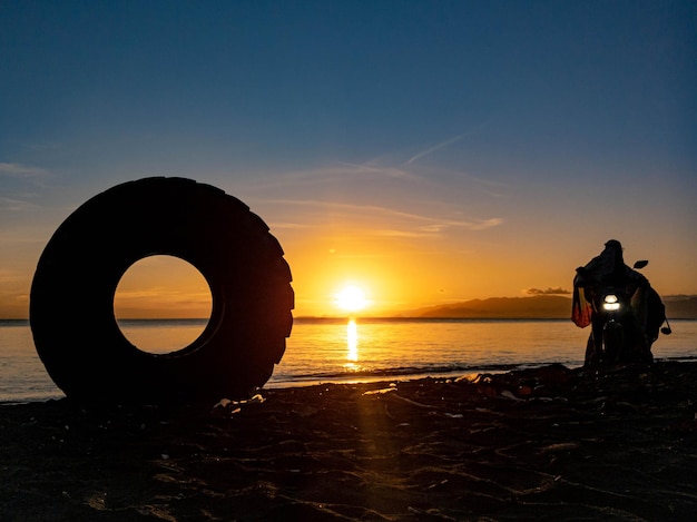 Silhouette of objects on the beach with sunrise