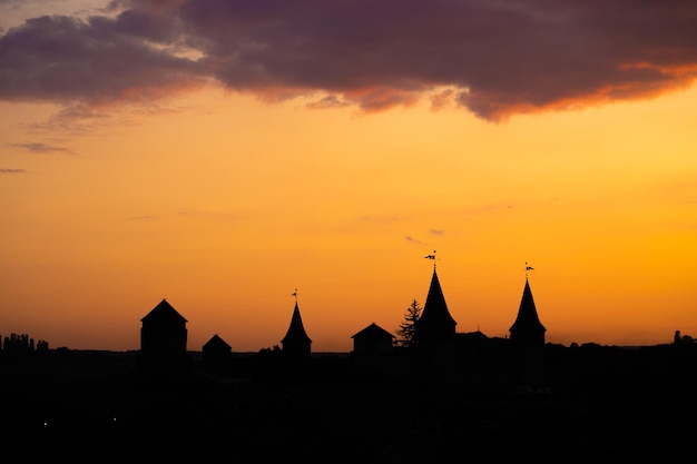 Silhouette of an old medieval castle during sunset