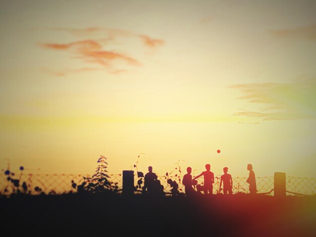 Silhouette people against sky during sunset