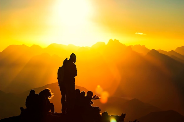 Silhouette people against sky during sunset