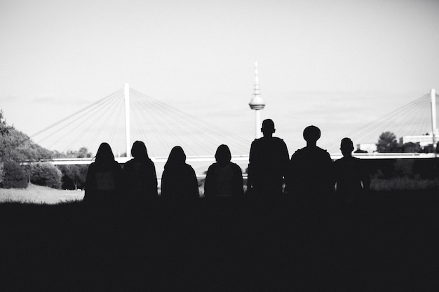 Silhouette people against sky