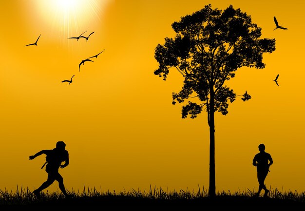 Silhouette people by tree on field against sky during sunset