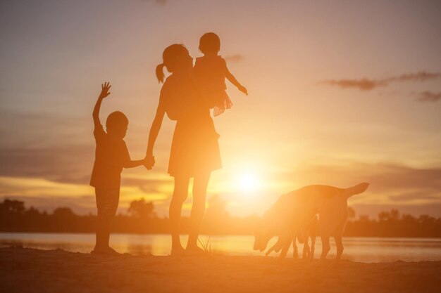 Photo silhouette people on land against sky during sunset