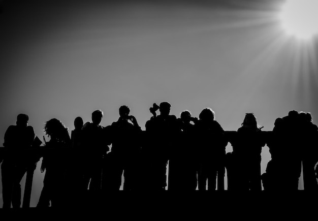 Silhouette people standing against clear sky