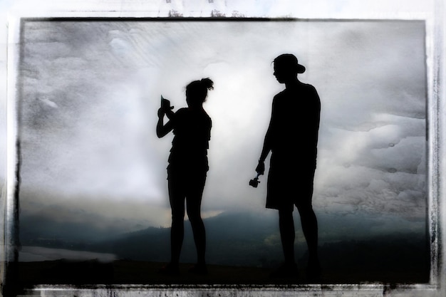 Фото Силуэт людей, стоящих на горе напротив неба