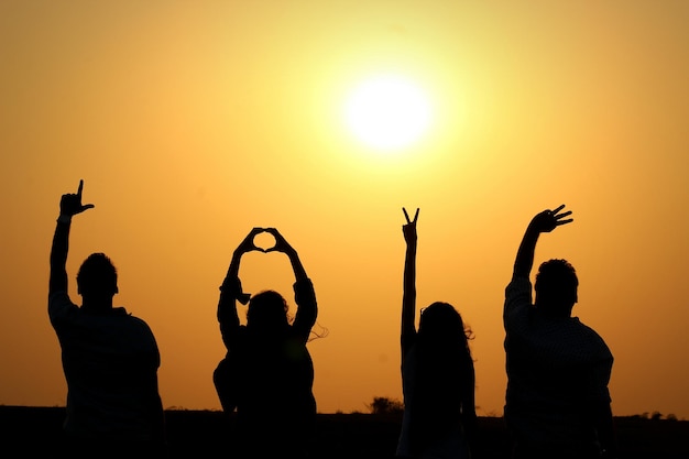 silhouette people at sunset