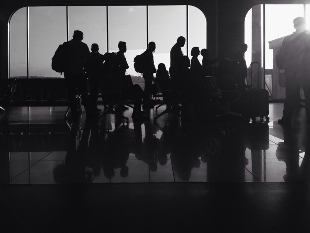 Silhouette people at waiting area in airport